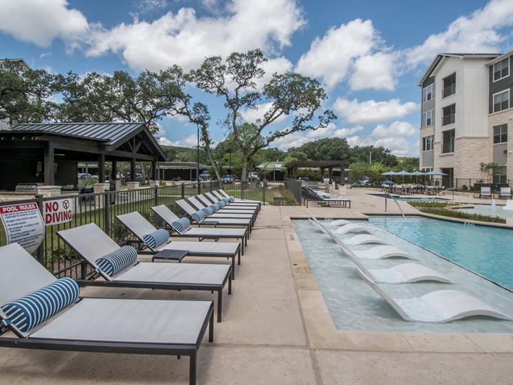 pool with lounge chair apartments in san antonio texas